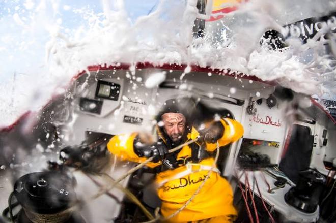 Onboard Abu Dhabi Ocean Racing - Ian Walker gets caught under a wave being thrown forward by the sudden braking of the boat as he adjusts the luff tension of the headsail in the Southern Ocean - Leg five to Itajai -  Volvo Ocean Race 2015 © Matt Knighton/Abu Dhabi Ocean Racing